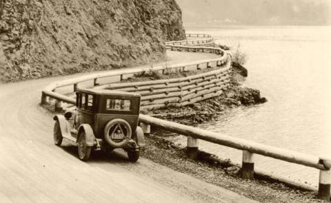 View of car on the winding Lake Crescent Highway, ca. 1920s.