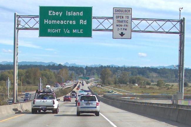 Image of Highway 2 eastbound overhead signs with static part-time shoulder sign.