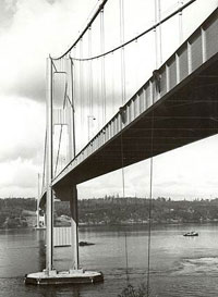 View of 1940 Narrows Bridge, looking west from the Tacoma side. Note tie-down cables attached to side span in foreground. WSDOT