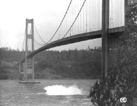 10:03 a.m. first section of concrete from roadway splashes into the Narrows below Galloping Gertie WSDOT