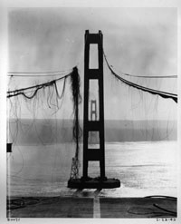 View of damaged cables and towers looking west, February 1943 WSDOT